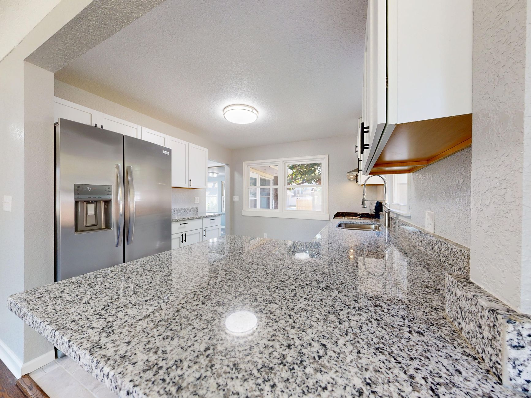 Spacious kitchen featuring granite countertops and stainless steel appliances in Riverside, CA